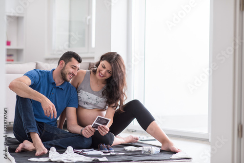 pregnant couple checking a list of things for their unborn baby