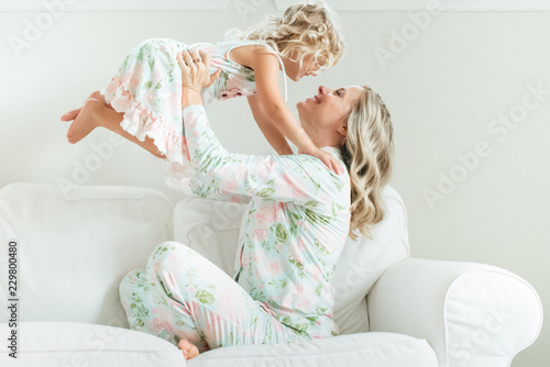 Mother bonding with her daughter on the sofa photo