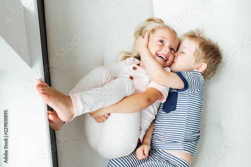 Brother gives a kiss to his sister
