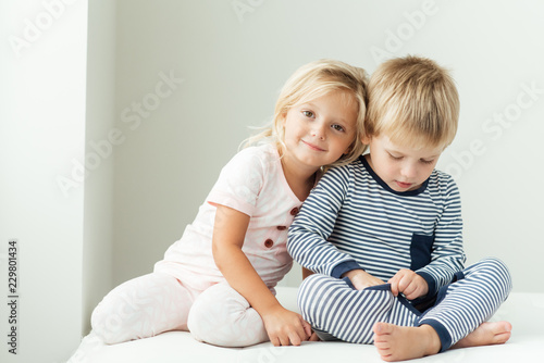 Smiling girl leaning on brother