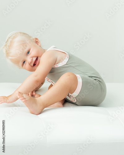 Smiling girl sitting and bending over
