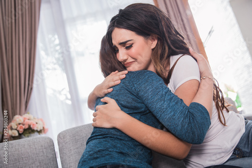 depressed woman being embrace by her friend