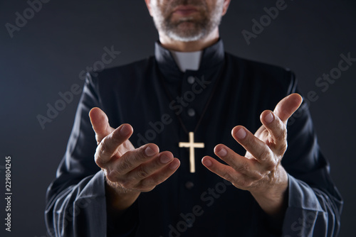 Priest open hands arms praying photo