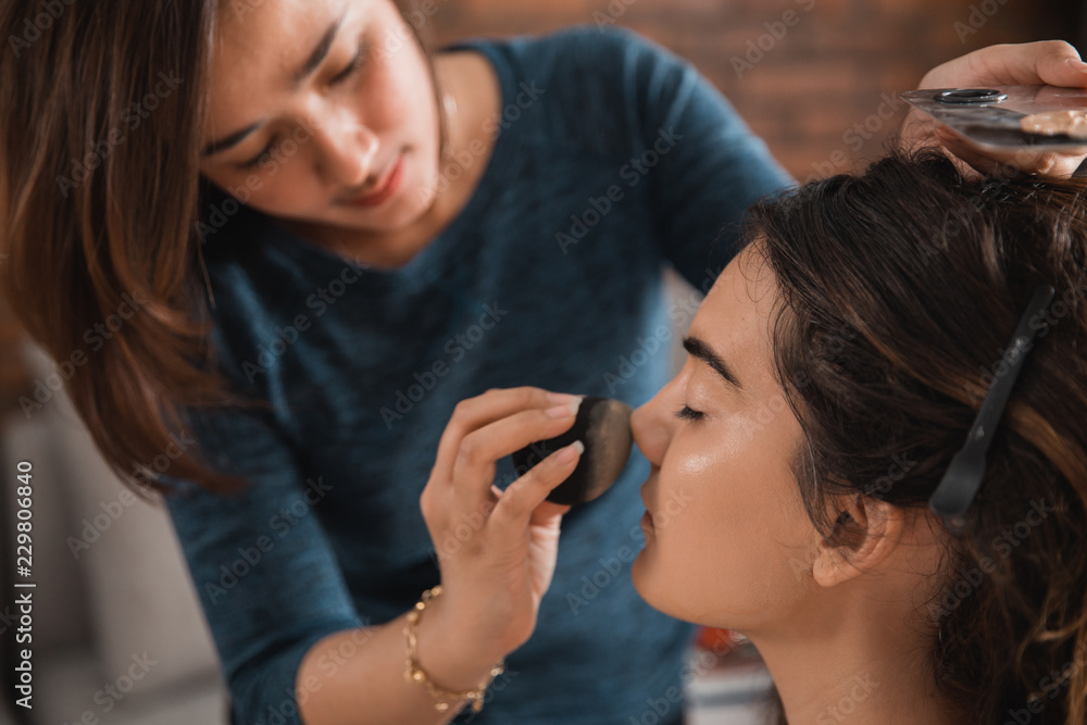 make up artist applying foundation make up artist applying foundation