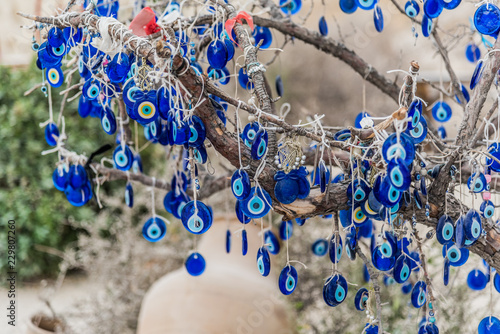 Hanging blue evil eyes (Nazar Boncugu) on the tree photo