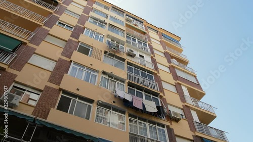 Facade of a large residential building with many floors, panoramic photo