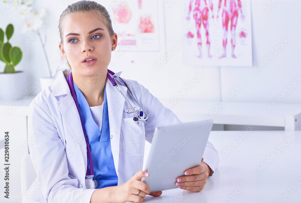 A young female doctor at a desk in the office. The concept of health and medicine