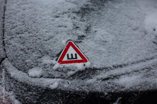 a black car back glass covered with snow