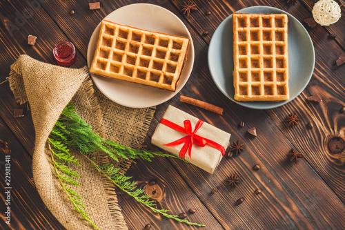 fresh belgian Tasty waffles and gifts on a wooden background. top view. photo