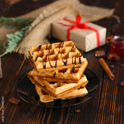 fresh belgian Tasty waffles and gifts on a wooden background. top view. photo