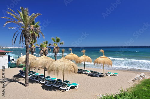 Beach in the popular resort of Marbella in Spain, Costa del Sol, Andalucia region, Malaga province. photo