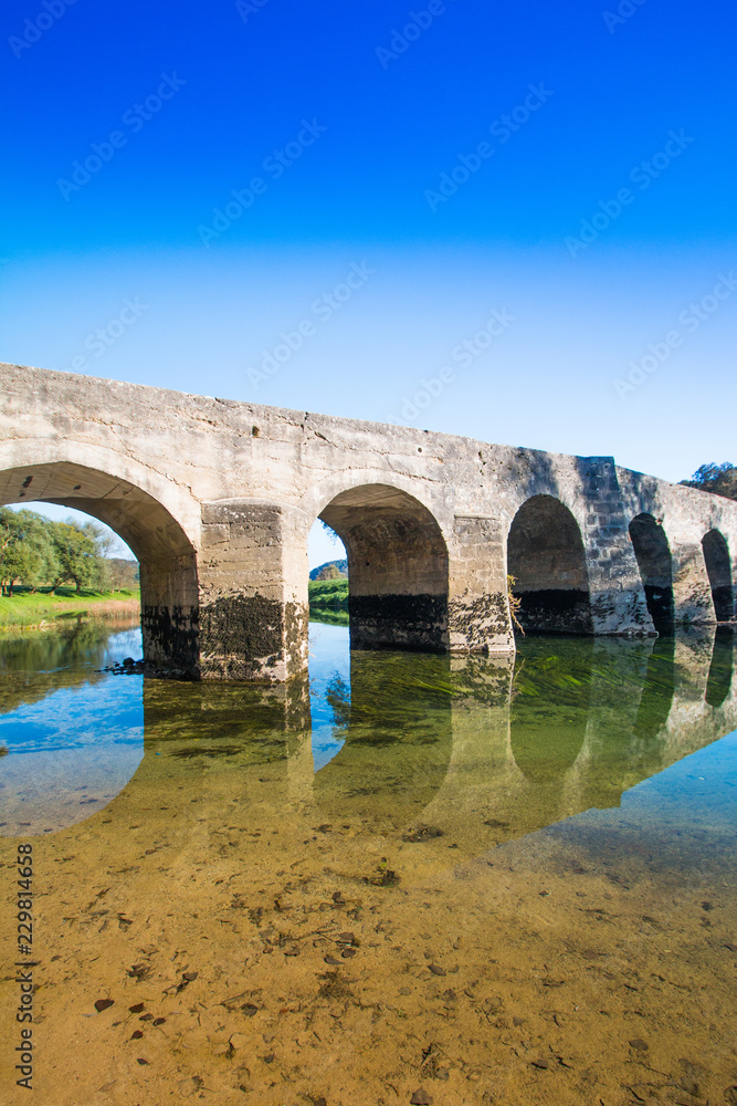 Croatian river Dobra, beautiful old stone bridge in village of Novigrad, Karlovac county, countryside landscpae 