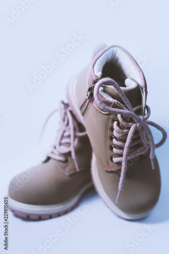 baby's pink shoes on gray background