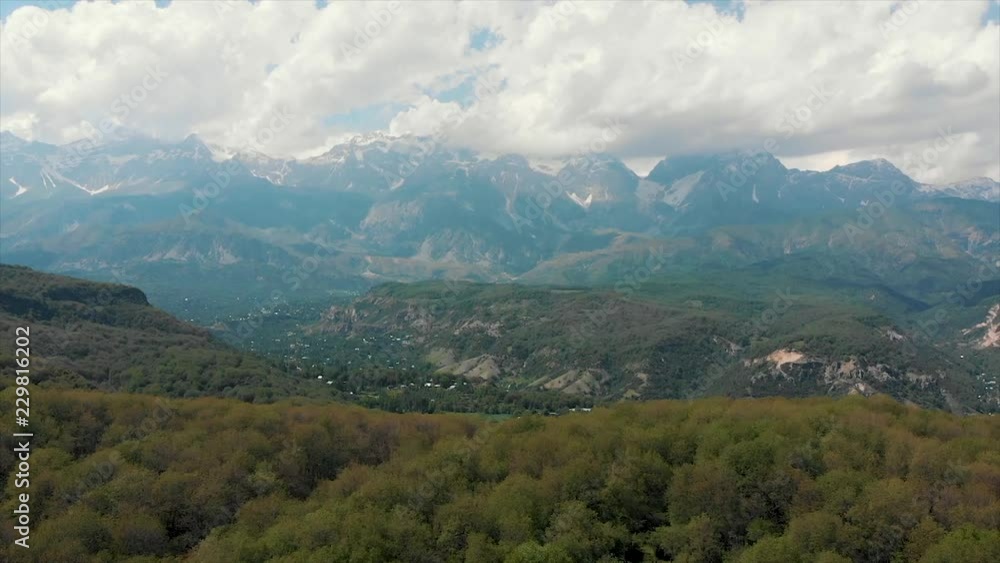 Arslanbob Is a Valley, Mountain Range, and a Large Wild Walnut (Juglans Regia) Forest in Jalal-abad Province of Western Kyrgyzstan. Here, the Trees Can Reach a Height of 30 Meters .Arial Dron Shoot. Arslanbob Is a Valley, Mountain Range, and a Large Wild Walnut (Juglans Regia) Forest in Jalal-abad Province of Western Kyrgyzstan. Here, the Trees Can Reach a Height of 30 Meters .Arial Dron Shoot.