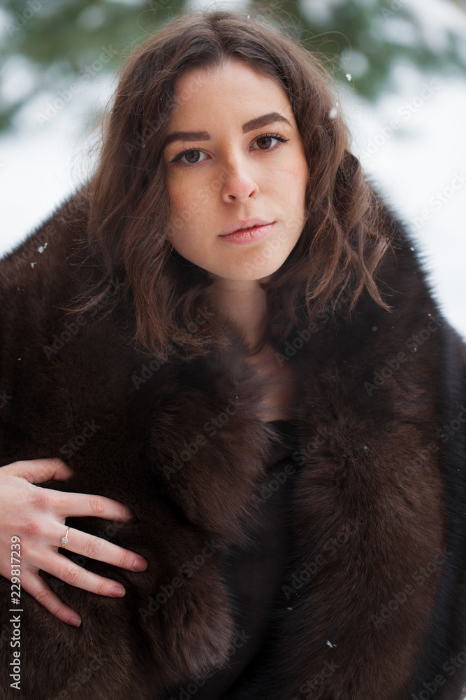 Beautiful elegant brunette woman wearing fur coat Beautiful elegant brunette woman wearing fur coat