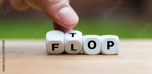 Hand is turning dice and changes the word Flop to Top