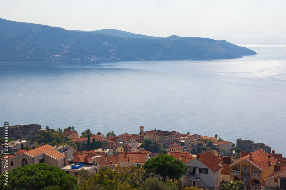 Beautiful Mediterranean landscape. Montenegro, Adriatic Sea. View of Bay of Kotor, Lustica peninsula and red roofs of seaside town of Herceg Novi