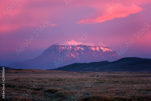 Amazing pink sunset landscape  Iceland. Snow capped peak of the volcanic mount scenic view  travel background