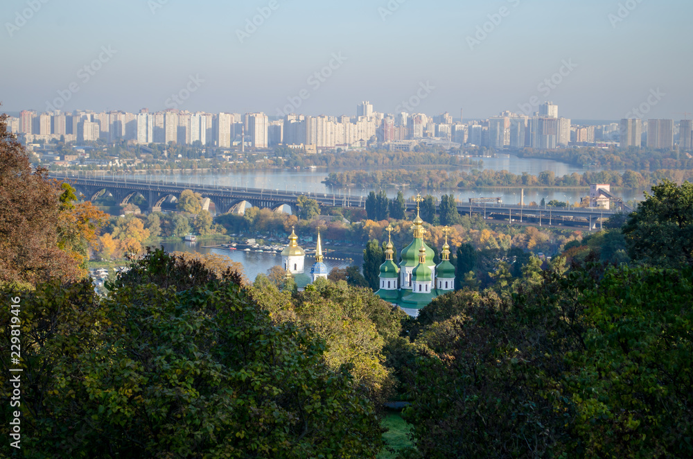 Beautiful landscape of the autumn city of Kiev. View of the river and church