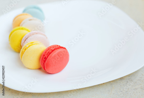 multi-colored macaroons on a white plate