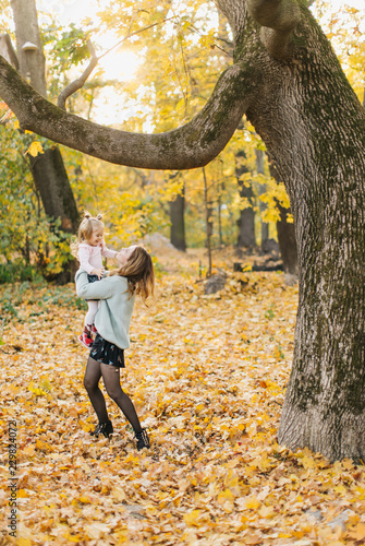 young mother with daughter are walking in the park in the golden autumn © Dmitriy Kapitonenko