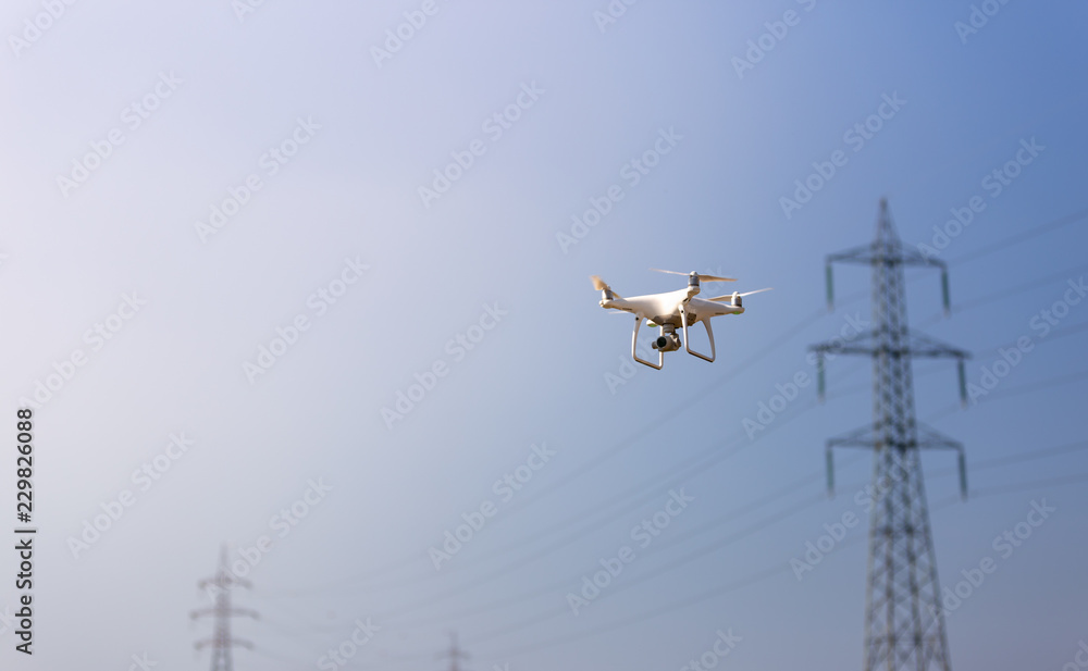 Flying drone doing an industrial inspection Flying drone doing an industrial inspection