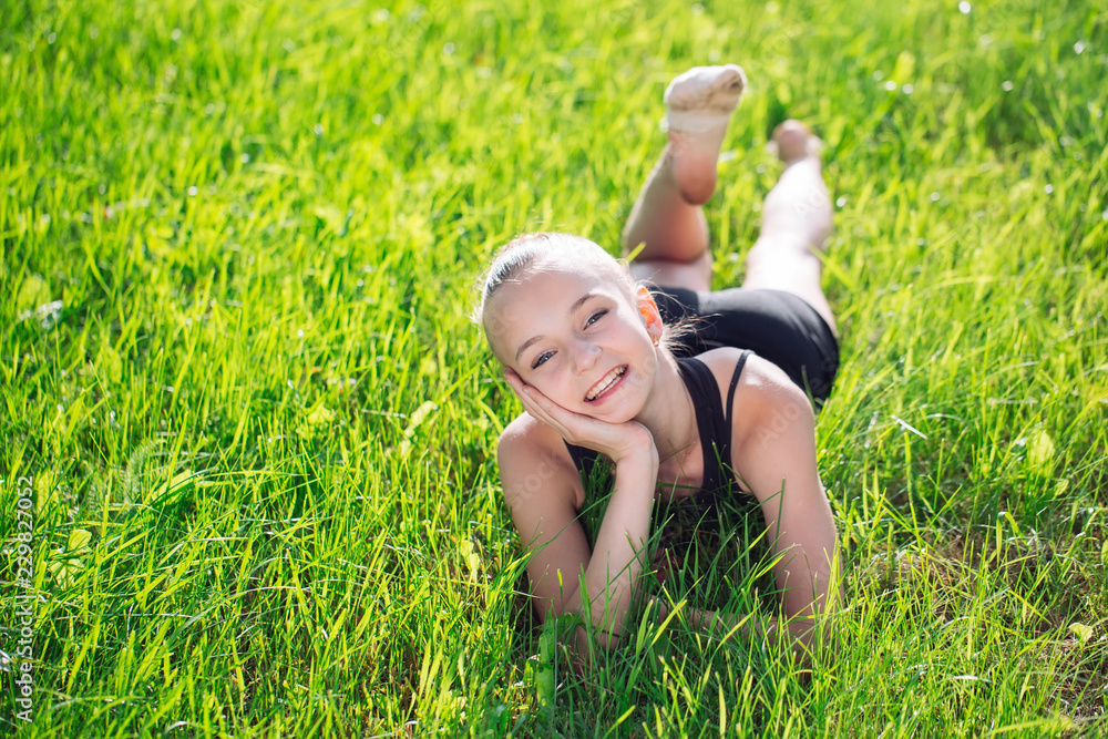 cute happy little girl lying on the grass cute happy little girl lying on the grass