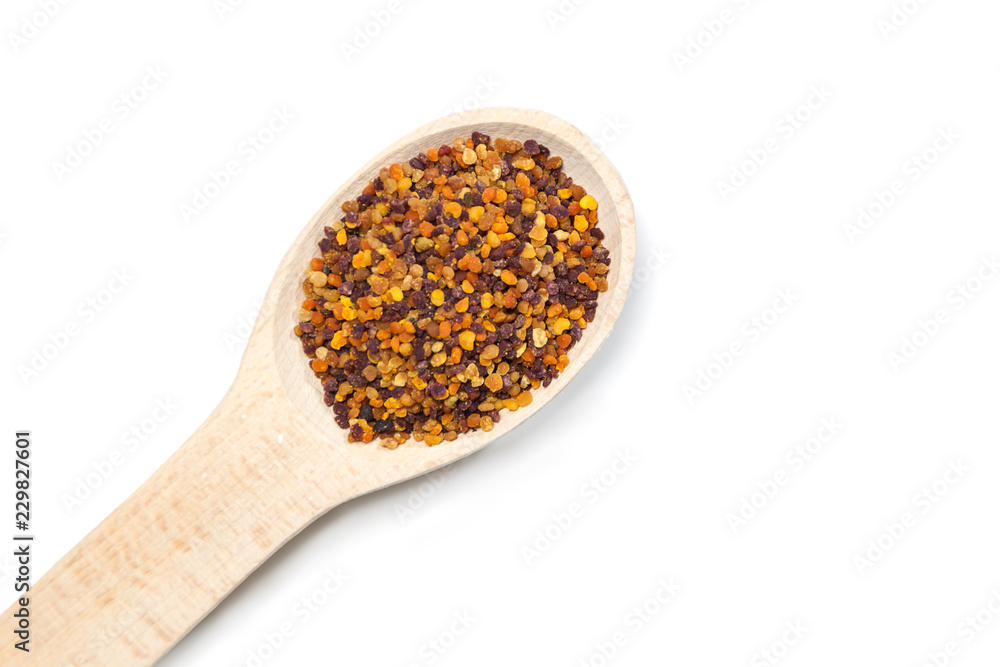 Bee pollen in the wooden spoon on white background Bee pollen in the wooden spoon on white background