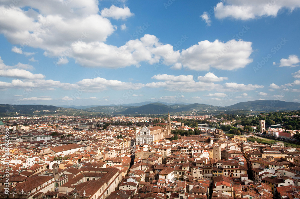 Beautiful cloudscape over historical center with narrow streets, ancient Tuscany houses and river of Florence, Italy. UNESCO World Heritage Site