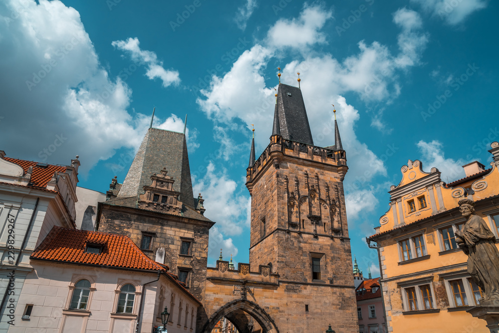 Fototapeta premium Gothic tower of the charles bridge aganst the blue sky in Prague