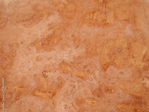 close up of a rough textured ocher stone wall background