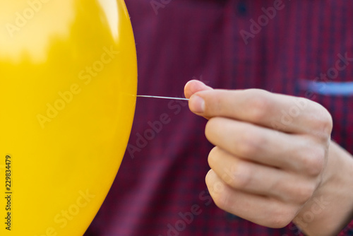 hands holding needle and balloon, patience and confidence concept f