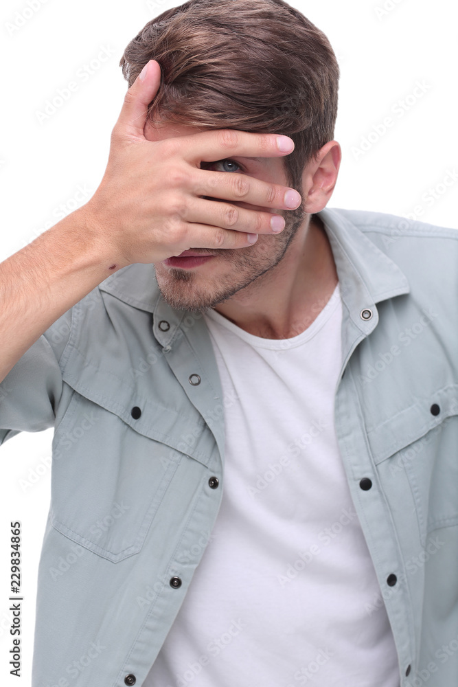 close up.young man covering his face with his hands close up.young man covering his face with his hands