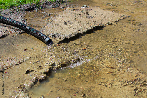 Water flowing out of a discharge hose photo