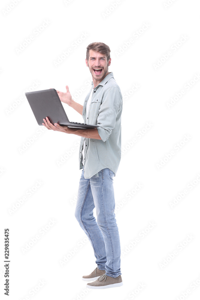 in full growth.happy young man with laptop in full growth.happy young man with laptop