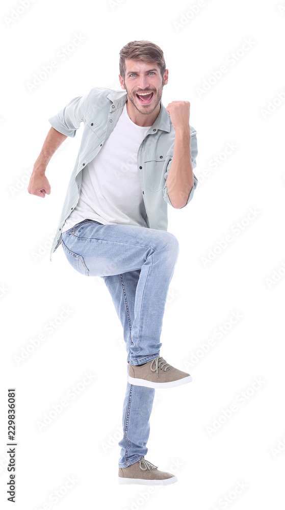 full-length. a happy young man steps forward full-length. a happy young man steps forward