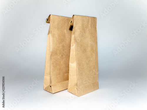 two Kraft paper bags on a light background