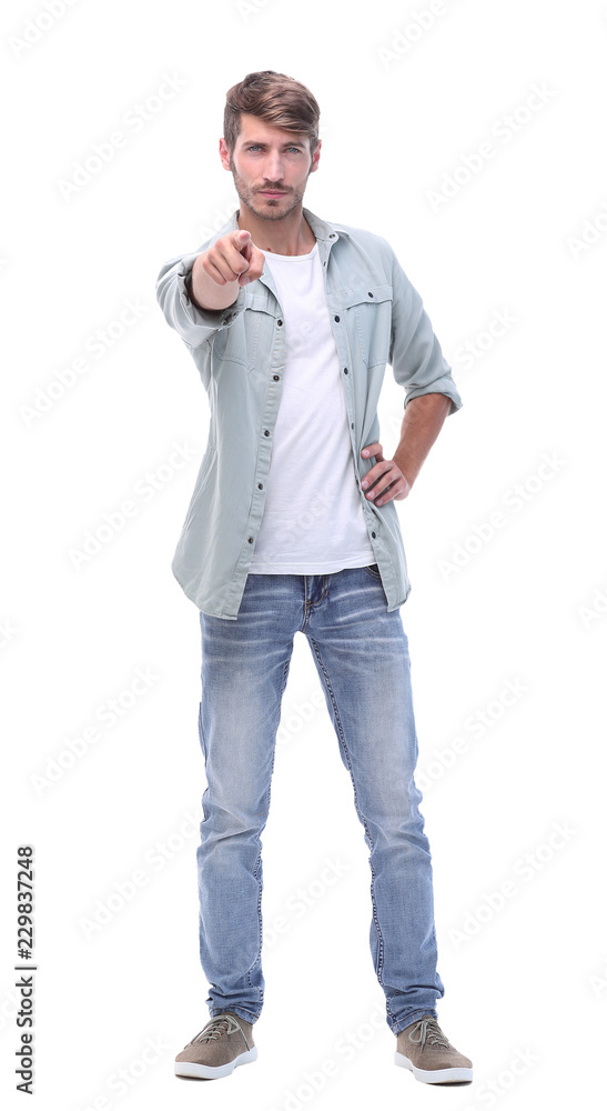 in full growth. modern young man pointing at you in full growth. modern young man pointing at you