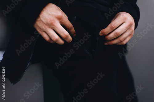 man shows zipper pocket. Sportswear. Details of sport clothing