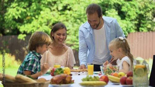 Father bringing just delivered pizza to hungry family, smelling fragrant food