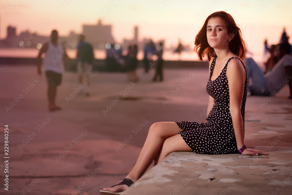 Wall Mural Beautiful  hispanic girl looking romantic at sunset in Havana