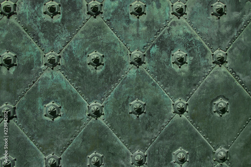 Metal ancient background with green iron decorative figures