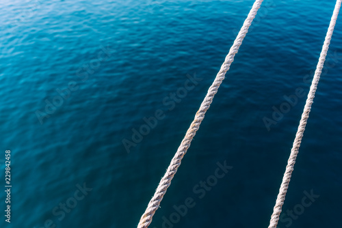 Capes of a boat crossing with the sea in the background and room for text.