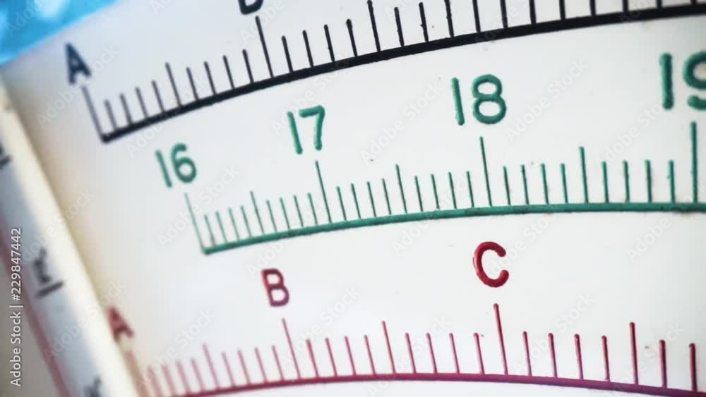 Camera slowly moves along parallel with length of face of old style scales, revealing mesaurement markings as it moves. Camera slowly moves along parallel with length of face of old style scales, revealing mesaurement markings as it moves.
