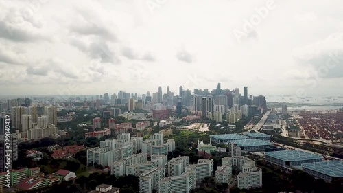 Drone flying backwards over and away from the large amazing city  centre of Singapore photo