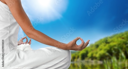 Young beautiful woman doing yoga  on background