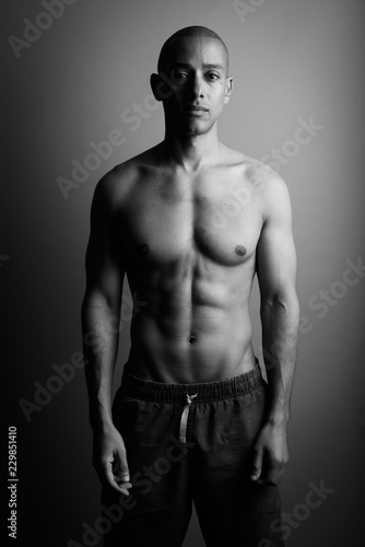 Handsome bald man shirtless in black and white
