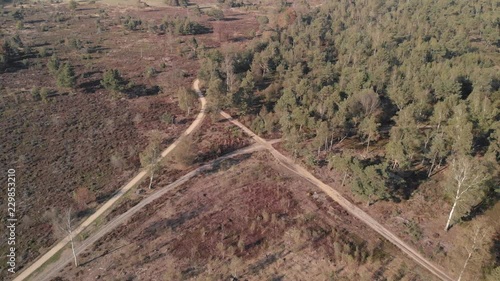 Crossing of roads in a moorland landscape seen from above backing off showing the wider trail patterns photo