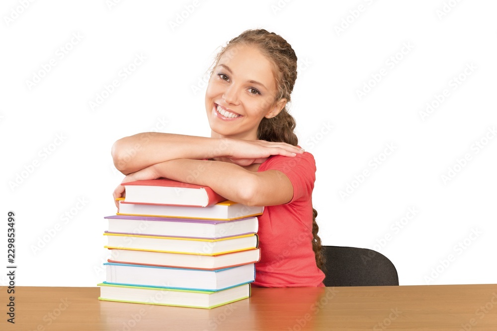 Friendly Young Girl Sitting Behind a Desk with a Books - Friendly Young Girl Sitting Behind a Desk with a Books -
