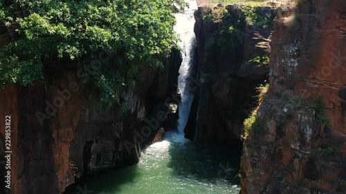 Aerial drone shot of a river with a waterfall in the jungle of South Africa. photo